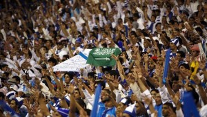 Fans of Saudi Al-Hilal hold a Saudi flag