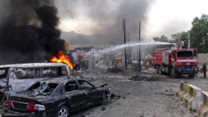 Fire fighters try to extinguish fire at the site of a suicide car bombing outside the Yemeni President Abd-Rabbu Mansour Rabbu Hadi's residence in the southern city of Aden