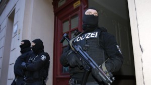 German special police units guard an entrance of an apartment building in the Wedding district in Berlin