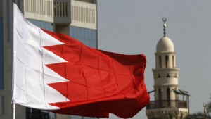 A Bahraini flag raised by protesters flutters in front of a local mosque during an anti-government demonstration at the Bahrain Financial Habour in Manama