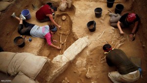 American archaeology students unearth a skeletons and clay jars during excavation works at the first-ever Philistine cemetery at Ashkelon National Park in southern Israel