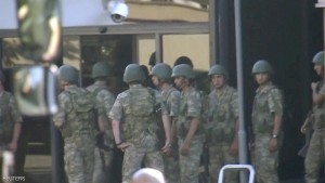 A still image from video shows armed soldiers waiting at the entrance of TRT state television as they prepare to surrender to the police after a failed coup attempt, in Istanbul