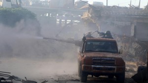 Free Syrian Army fighters shoot a weapon on the back of a pick-up truck in Ramousah area southwest of Aleppo