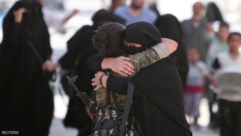 A woman embraces a Syria Democratic Forces (SDF) fighter after she was evacuated with others by the SDF from an Islamic State-controlled neighbourhood of Manbij