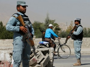 Afghan policemen stand guard at a checkpoint near the site of kidnapping in Kabul,