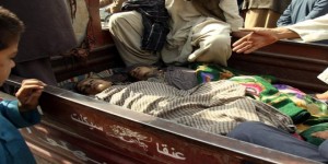Relatives and members of civilians sit next the dead bodies of children who were killed during clashes between Afghan security forces and the Taliban in Kunduz, Afghanistan