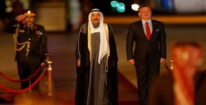 Jordan's King Abdullah II stands next to Emir of Kuwait Sabah Al-Ahmad Al-Jaber Al-Sabah during a reception ceremony at the Queen Alia International Airport in Amman