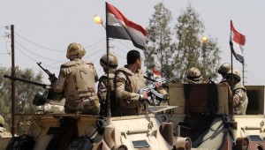 Soldiers in military vehicles proceed towards al-Jura district in El-Arish city from Sheikh Zuwaid
