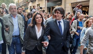 Sacked Catalan President Carles Puigdemont walks with his wife Marcelo Topor after leaving a restaurant the day after the Catalan regional parliament declared independence from Spain in Girona