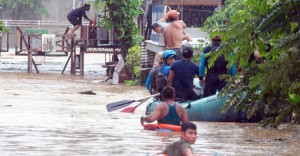 Rescuers evacuate residents from their homes during heavy flooding in Cagayan de Oro city in the Philippines