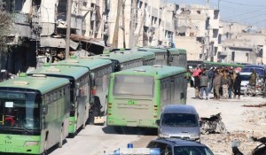 People get on buses to be evacuated from al-Sukkari rebel-held sector of eastern Aleppo