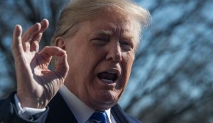 TOPSHOT - US President Donald Trump speaks to the press at the White House in Washington, DC on December 16, 2017 before departing for the Camp David presidential retreat in Maryland. / AFP / NICHOLAS KAMM