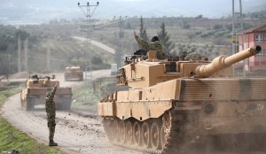 A Turkish military convoy arrives at a village on the Turkish-Syrian border in Kilis province