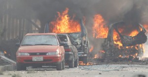 Vehicles are seen on fire after a blast in Jalalabad