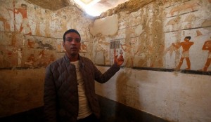 A guide from the Ministry of Antiquities inspects a discovery from Egypt’s antiquities authorities at the Giza plateau, the site of the three ancient pyramids on the outskirts of Cairo