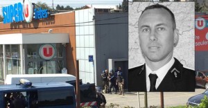 Police are seen at the scene of a hostage situation in a supermarket in Trebes