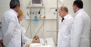 Russian President Vladimir Putin meets with victims injured during a fire in a shopping mall, at a hospital in Kemerovo