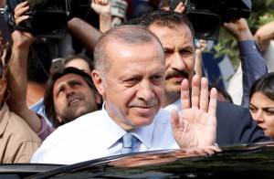 Turkish President Tayyip Erdogan waves to supporters as he leaves his residence in Istanbul