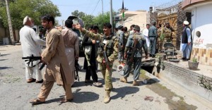 Afghan security force stand at the site of a suicide attack in Jalalabad city