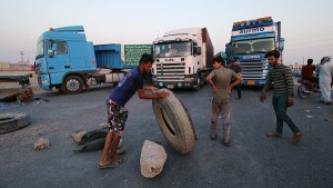 Protesters block the road to Iraq's Umm Qasr port, south of Basra