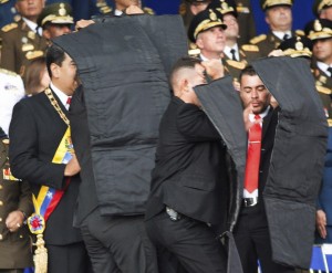 4ED763BA00000578-6027507-Security_personnel_shield_Maduro_after_the_explosions_which_came-a-135_1533444093087