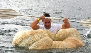 A man paddles his giant pumpkin boat during the raditional pumpkin race in Lohmar